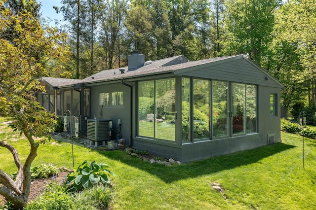 110 Sherwood Hill Rd, Brewster, NY 10509 - rear view of property with a sunroom, a chimney, a yard, and central air condition unit