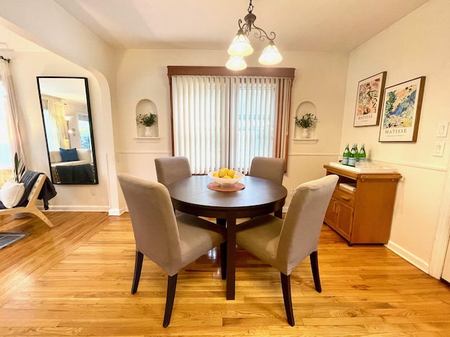 dining space featuring light wood-style floors and baseboards