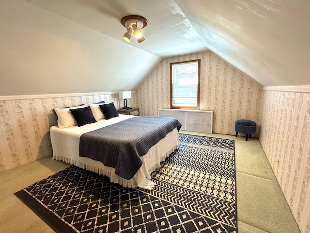 bedroom with carpet flooring, wallpapered walls, lofted ceiling, and radiator