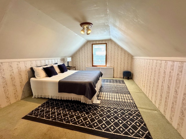 bedroom featuring carpet floors, wallpapered walls, and vaulted ceiling