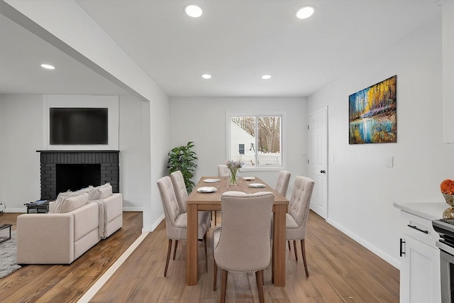 121 Arlington Ave, Wyandanch, NY 11798 - dining area featuring recessed lighting, light wood finished floors, baseboards, and a brick fireplace