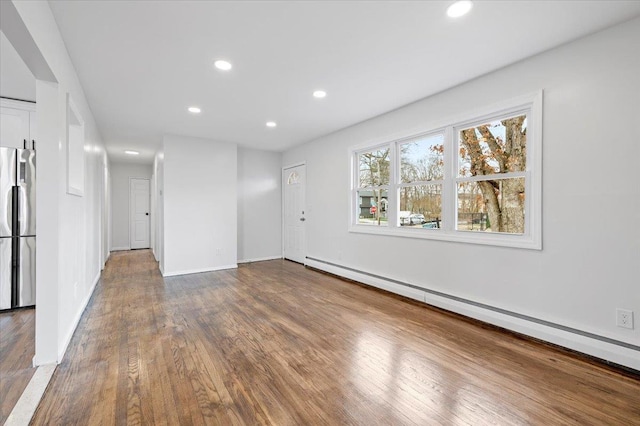 121 Arlington Ave, Wyandanch, NY 11798 - unfurnished living room featuring a baseboard radiator, wood finished floors, recessed lighting, and baseboards