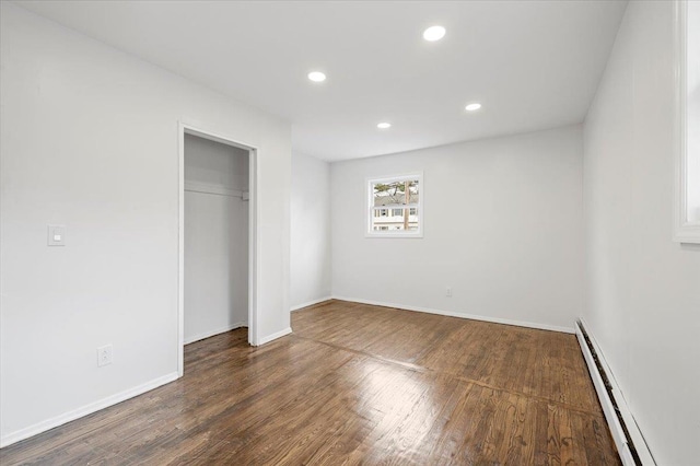 121 Arlington Ave, Wyandanch, NY 11798 - unfurnished bedroom with a baseboard heating unit, wood finished floors, recessed lighting, baseboards, and a closet