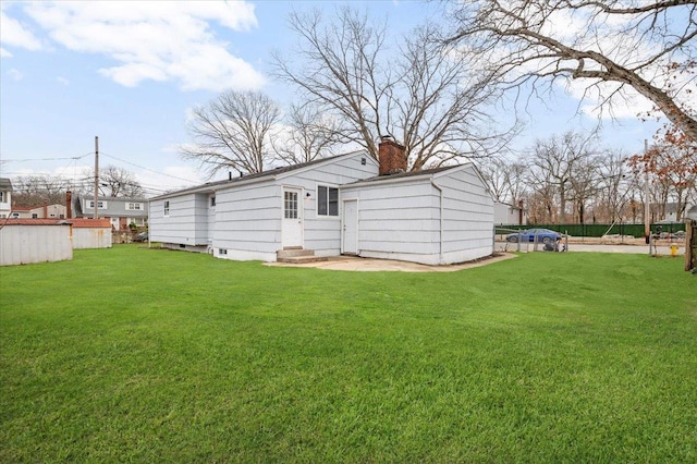 121 Arlington Ave, Wyandanch, NY 11798 - rear view of property featuring entry steps and a chimney