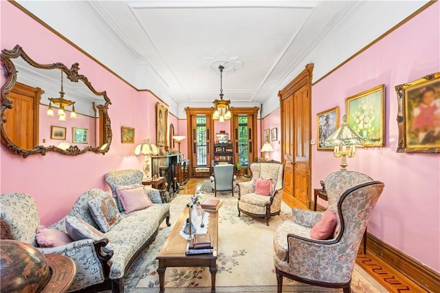 living area with a chandelier, wood finished floors, and ornamental molding
