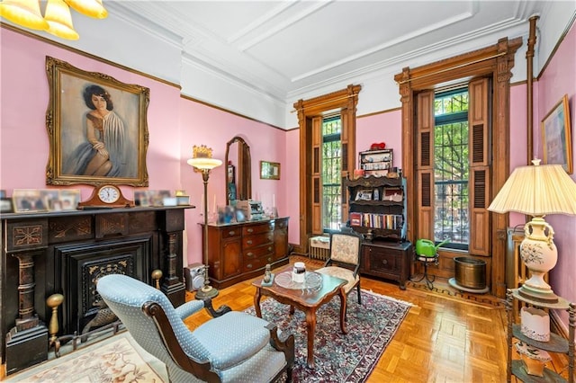 living area with a fireplace and crown molding