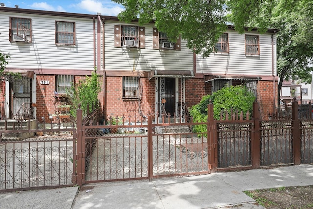 793 Jackson Ave, Bronx, NY 10456 - multi unit property with a fenced front yard, brick siding, a gate, and cooling unit