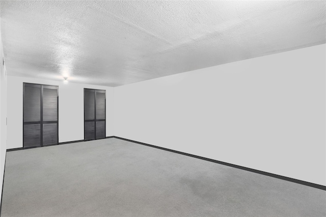 793 Jackson Ave, Bronx, NY 10456 - unfurnished room featuring a textured ceiling, baseboards, and carpet