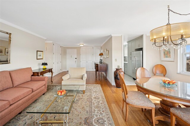 555 Kappock St Unit 20L, Bronx, NY 10463 - living area with light wood-style flooring, a chandelier, ornamental molding, and baseboards