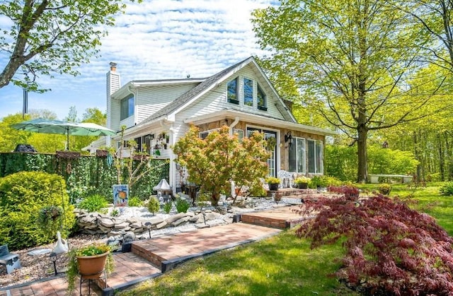 559 Noxon Rd, Poughkeepsie, NY 12603 - rear view of property with a chimney and a sunroom