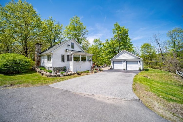 559 Noxon Rd, Poughkeepsie, NY 12603 - view of front of home with an outbuilding, a garage, a chimney, and a front lawn