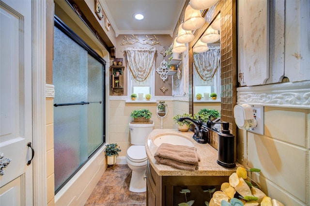 559 Noxon Rd, Poughkeepsie, NY 12603 - bathroom featuring toilet, bath / shower combo with glass door, vanity, ornamental molding, and stone finish floors