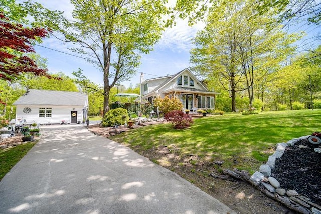 559 Noxon Rd, Poughkeepsie, NY 12603 - view of front of house featuring concrete driveway and a front lawn
