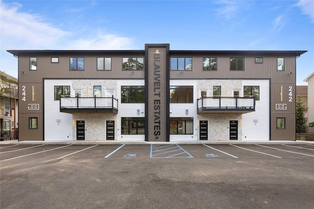 view of building exterior with uncovered parking