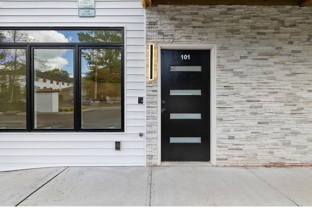 entrance to property with stone siding