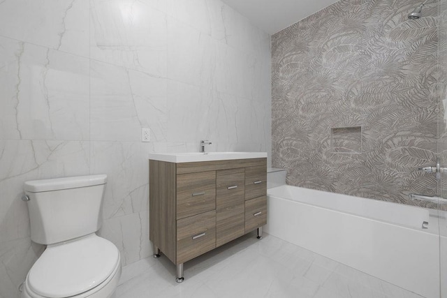 full bathroom with toilet, vanity, and wallpapered walls