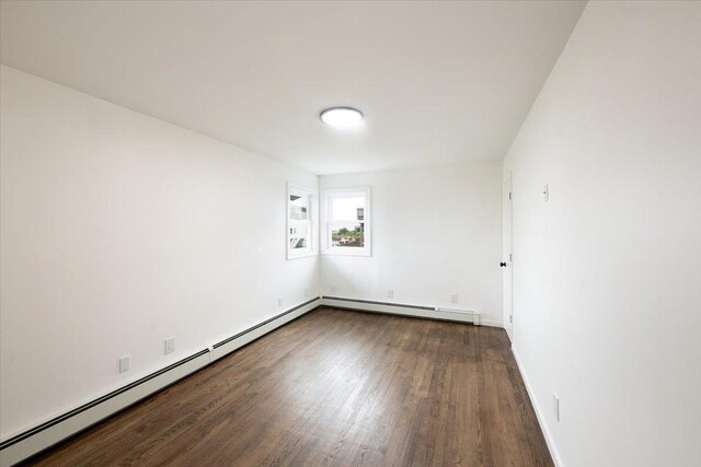 886 S 8th St, Lindenhurst, NY 11757 - unfurnished room with wood finished floors, a baseboard heating unit, and baseboards