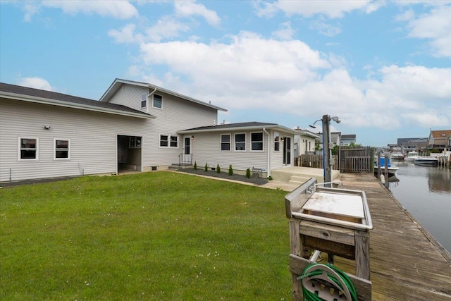 886 S 8th St, Lindenhurst, NY 11757 - rear view of property featuring a lawn and a water view