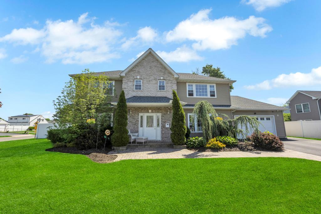59 Saddle Ln, Levittown, NY 11756 - view of front of home with a garage and concrete driveway