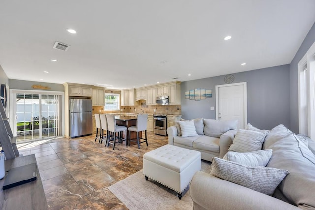 59 Saddle Ln, Levittown, NY 11756 - living room featuring healthy amount of natural light and recessed lighting