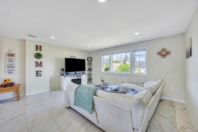 59 Saddle Ln, Levittown, NY 11756 - living area featuring light marble finish flooring, recessed lighting, and baseboards