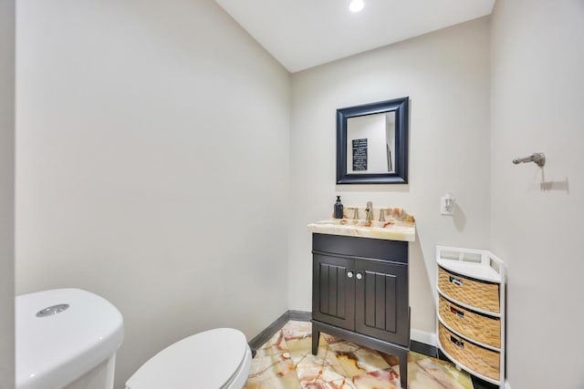 59 Saddle Ln, Levittown, NY 11756 - bathroom with toilet, baseboards, vanity, and recessed lighting