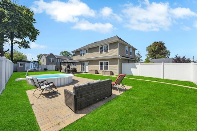 59 Saddle Ln, Levittown, NY 11756 - back of property featuring a gazebo, a storage unit, an outdoor living space, a patio, and an outbuilding
