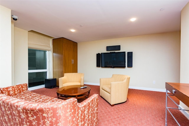 carpeted living area with baseboards and recessed lighting
