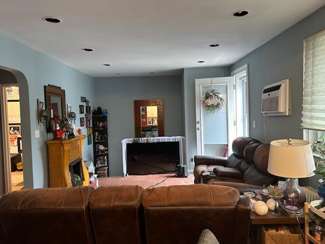 73-26 260th St Unit B, Glen Oaks, NY 11004 - living area featuring a wall mounted air conditioner and arched walkways