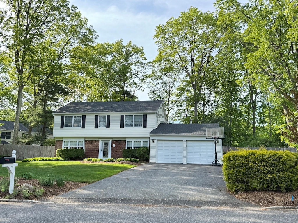 3 Sanford Ln, Stony Brook, NY 11790 - colonial inspired home with asphalt driveway, a garage, and brick siding