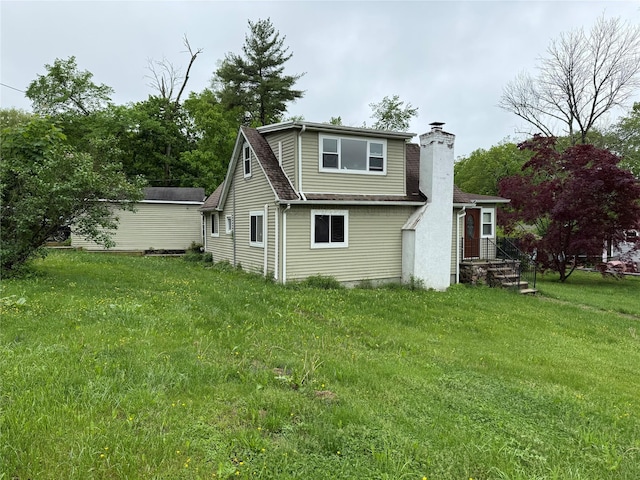 11 Glendale Rd, Greenwood Lake, NY 10925 - back of house featuring a chimney, a yard, and a shingled roof