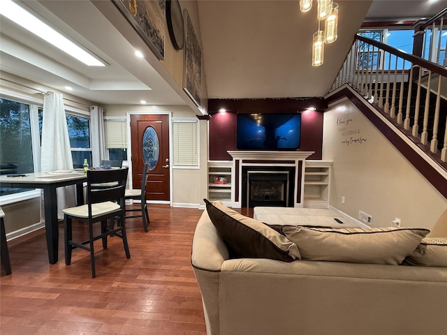 11 Glendale Rd, Greenwood Lake, NY 10925 - living area featuring wood finished floors, a fireplace, a chandelier, baseboards, and stairs