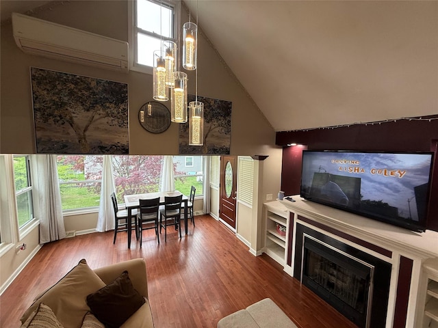 11 Glendale Rd, Greenwood Lake, NY 10925 - living area featuring a wall unit AC, wood finished floors, baseboards, high vaulted ceiling, and a fireplace