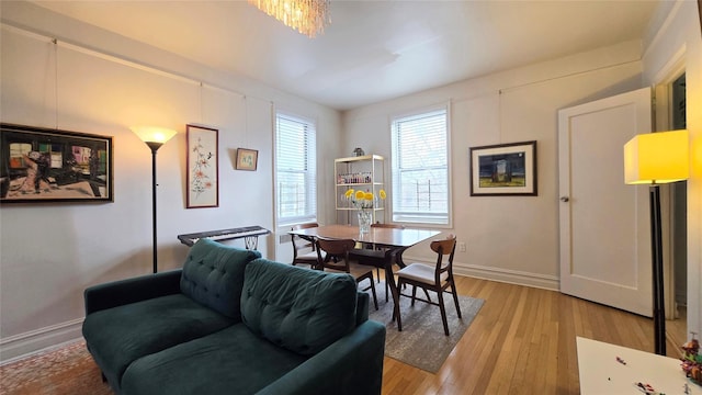 dining room featuring light wood-style flooring and baseboards