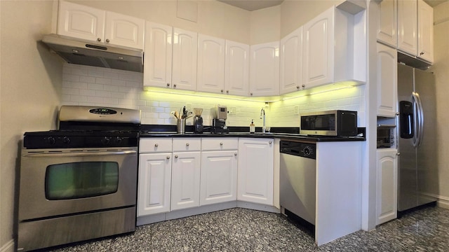 kitchen with stainless steel appliances, under cabinet range hood, white cabinets, and dark countertops