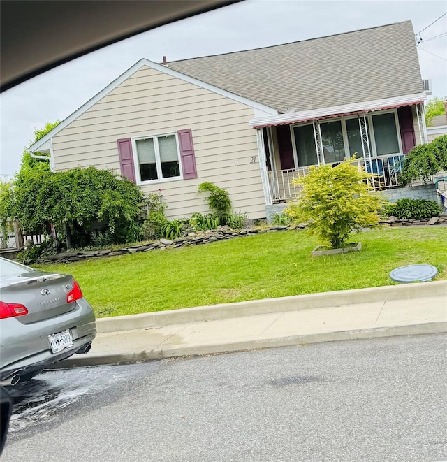 21 Abbott St, West Babylon, NY 11704 - view of front of property with a porch, roof with shingles, and a front lawn