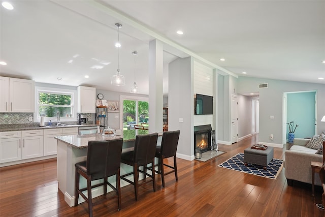 17 Kingswood Way, South Salem, NY 10590 - kitchen with lofted ceiling, plenty of natural light, dark wood-style flooring, white cabinetry, and light stone counters