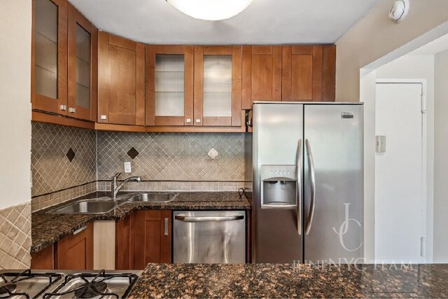 150-38 Union Tpke Unit 4K, Flushing, NY 11367 - kitchen featuring stainless steel appliances, brown cabinets, a sink, and dark stone counters