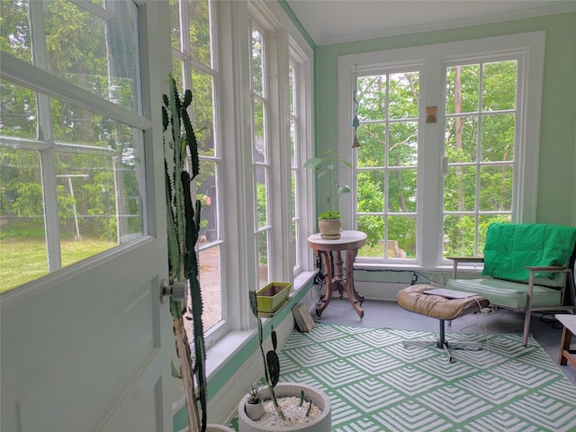 sunroom with french doors and ornamental molding