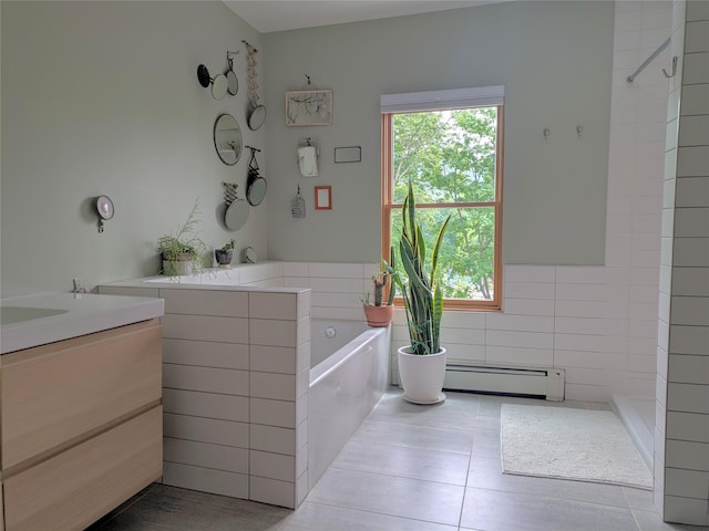 full bath with a baseboard radiator, tile walls, vanity, a tile shower, and healthy amount of natural light