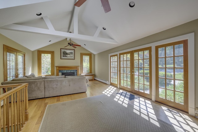 living area with ceiling fan, baseboard heating, a premium fireplace, and wood finished floors