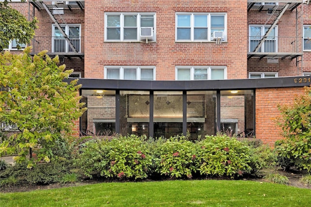 back of property featuring brick siding