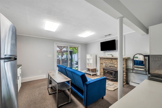 carpeted living area featuring baseboards, ornamental molding, and a wood stove