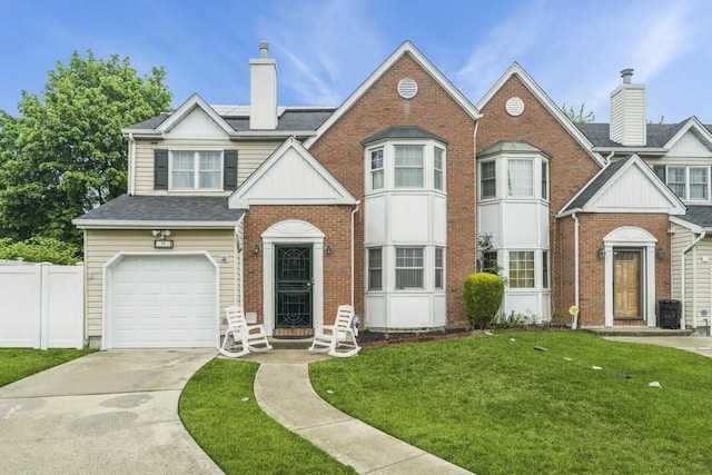 17 Bayview Ct, Inwood, NY 11096 - view of front of home with a chimney, brick siding, an attached garage, and driveway