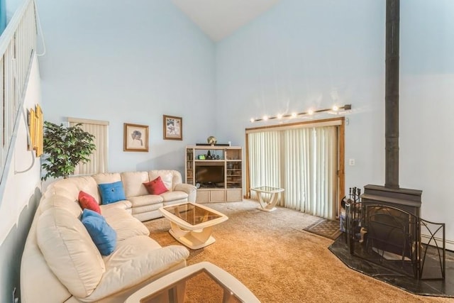 17 Bayview Ct, Inwood, NY 11096 - carpeted living area with high vaulted ceiling and a wood stove