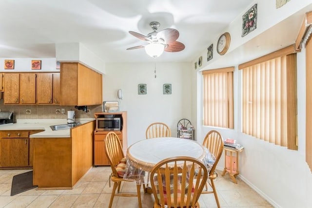 17 Bayview Ct, Inwood, NY 11096 - kitchen with stainless steel microwave, brown cabinets, a ceiling fan, and light countertops