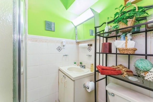 17 Bayview Ct, Inwood, NY 11096 - bathroom featuring tile walls, toilet, vanity, and wainscoting