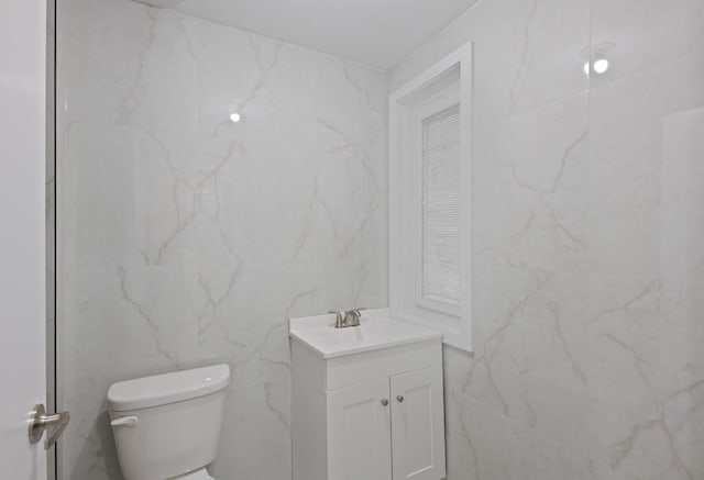 bathroom featuring toilet and vanity