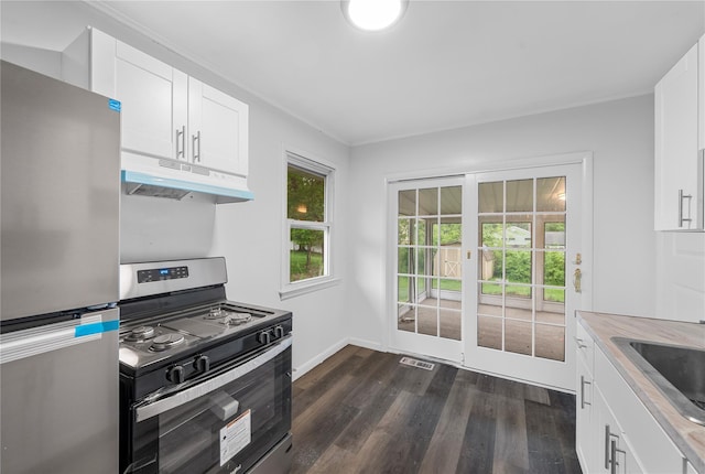 13 Barnett Rd E, Monroe, NY 10950 - kitchen featuring appliances with stainless steel finishes, under cabinet range hood, dark wood-style flooring, and white cabinetry