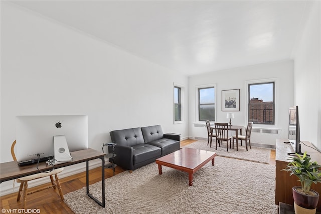 98-50 67th Ave Unit 6F, Rego Park, NY 11365 - living area with radiator heating unit, an office area, and wood finished floors